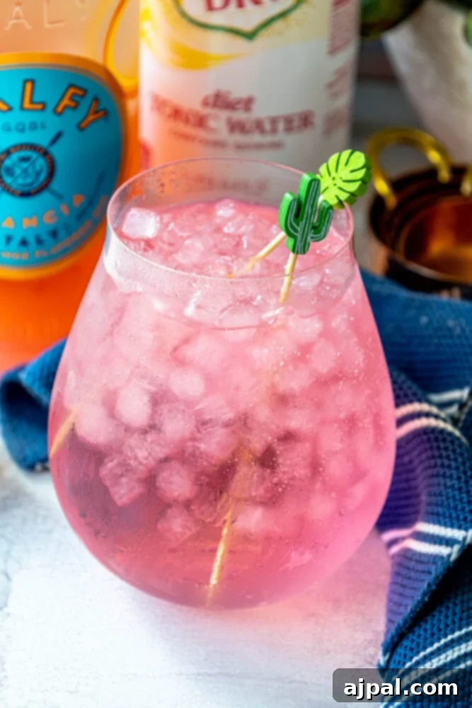Sunset Sip Blood Orange Gin Tonic 3 Refreshing pink drink with ice, Malfy Arancia Gin, and tonic water.