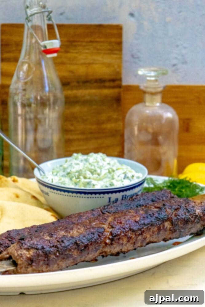 Effortless Griddled Greek Gyros 4 A vibrant platter showcasing Easy Griddled Greek Gyros, accompanied by a rich dip and fresh herbs.