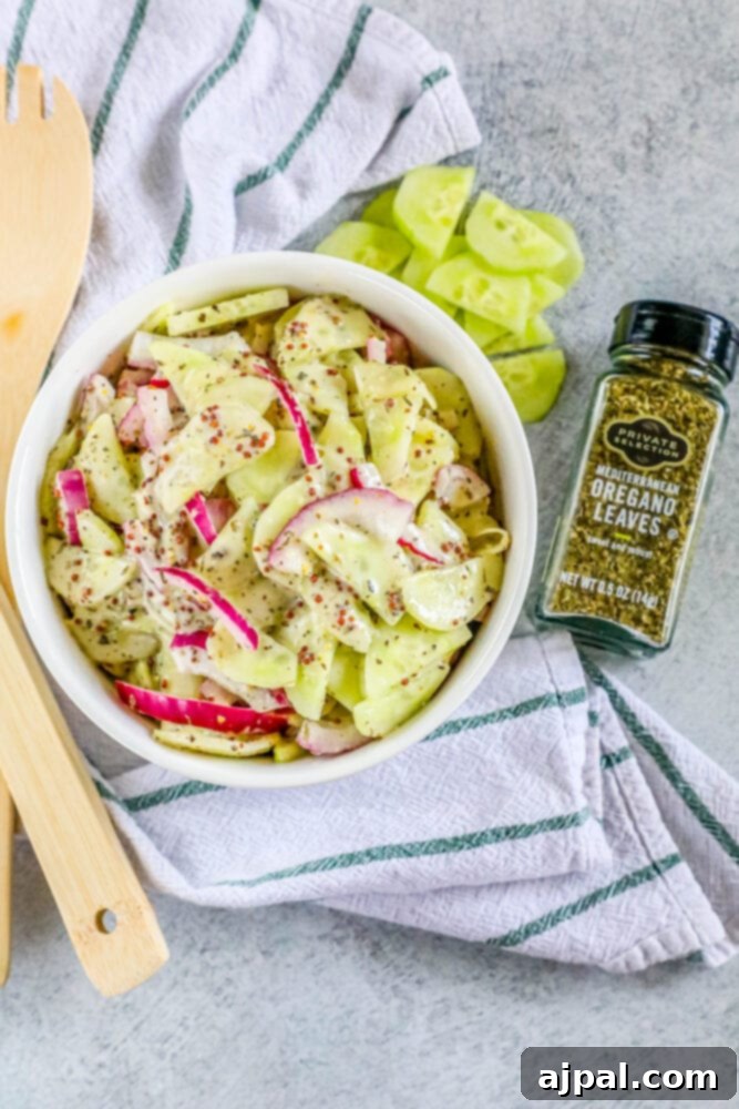 Cool Creamy Cucumber Salad 12 picture of creamy cucumber salad with onion and mustard in a bowl