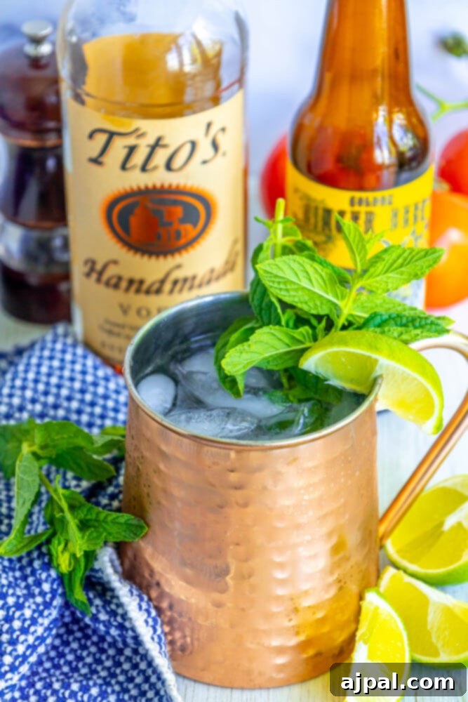 Moscow Mule Zesty Ginger Delight 4 A perfectly prepared Moscow Mule cocktail in a shiny copper mug, garnished with fresh mint sprigs and lime wedges, sitting on a table.