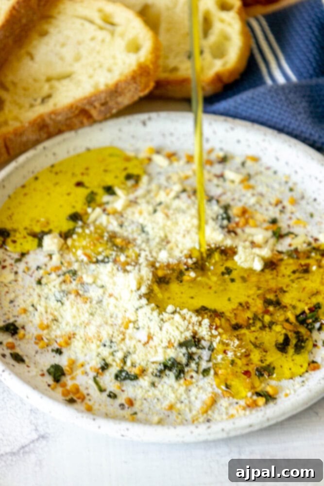 Effortless Bread Dip Perfection 6 A simple yet elegant composition shows a bowl of olive oil bread dip ingredients before mixing, emphasizing the ease of the recipe.