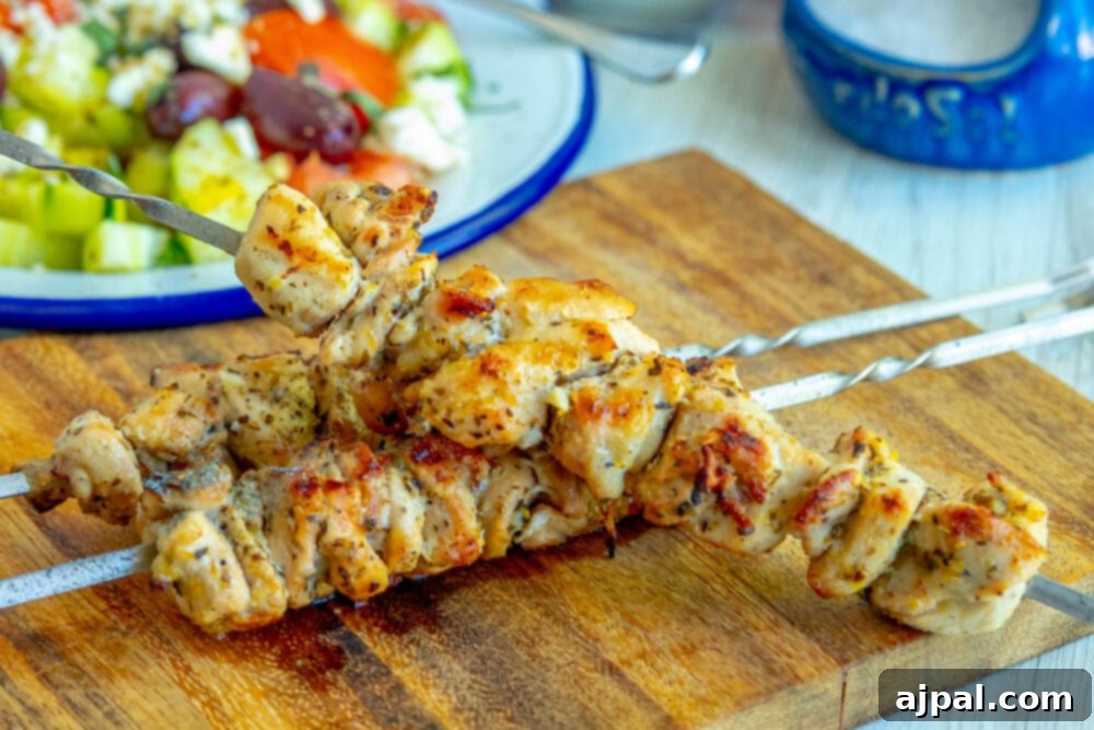 Close-up of succulent grilled chicken souvlaki skewers artfully arranged on a wooden cutting board