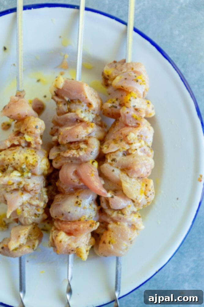 Marinated chicken pieces threaded onto wooden skewers, ready for grilling