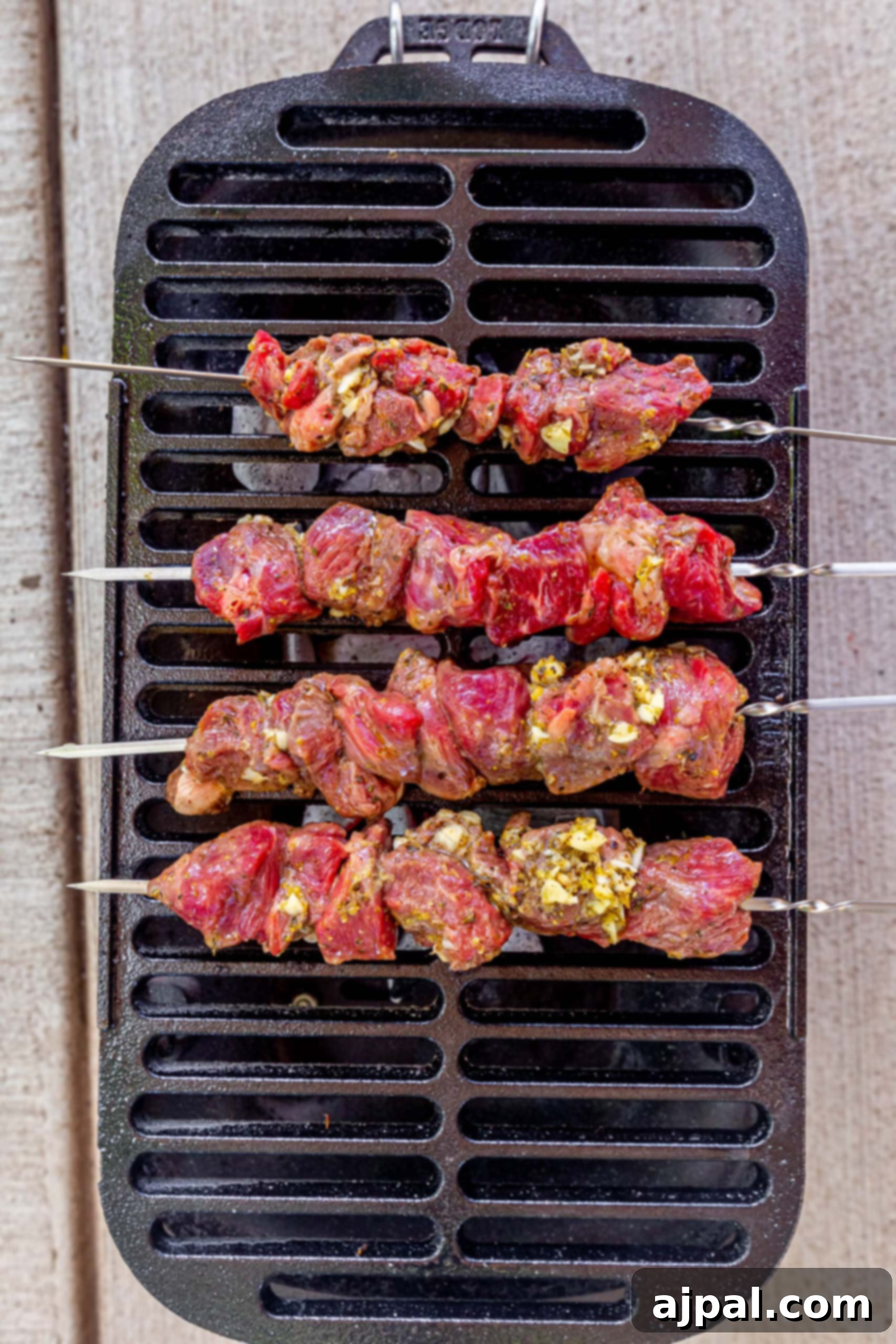 Classic Grilled Lamb Souvlaki Skewers 6 picture of raw lamb souvlaki on a skewer on a cast iron grill