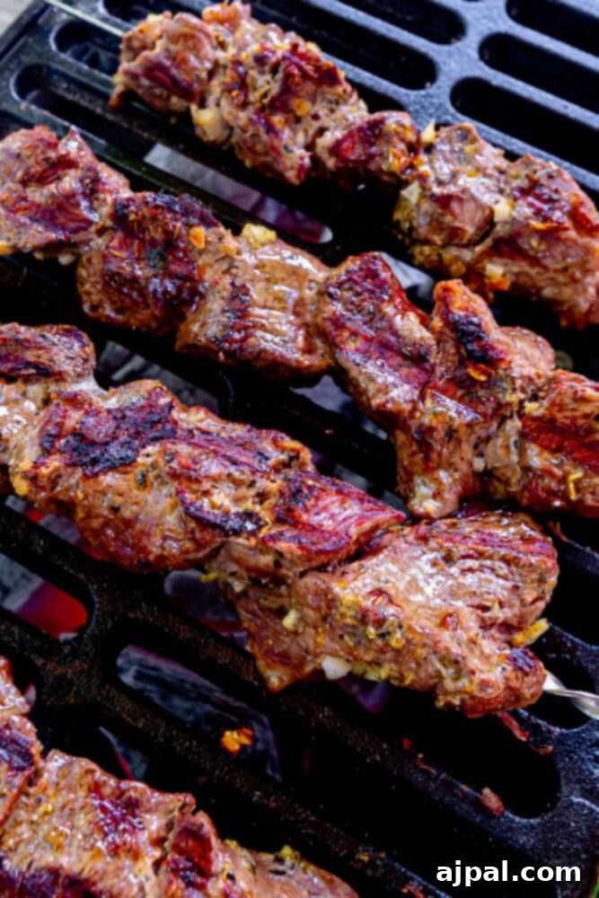 Classic Grilled Lamb Souvlaki Skewers 9 picture of lamb souvlaki on a skewer on a cast iron grill