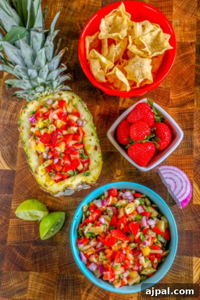 Picture of strawberry pineapple salsa in a hollowed out pineapple, vibrant and colorful.