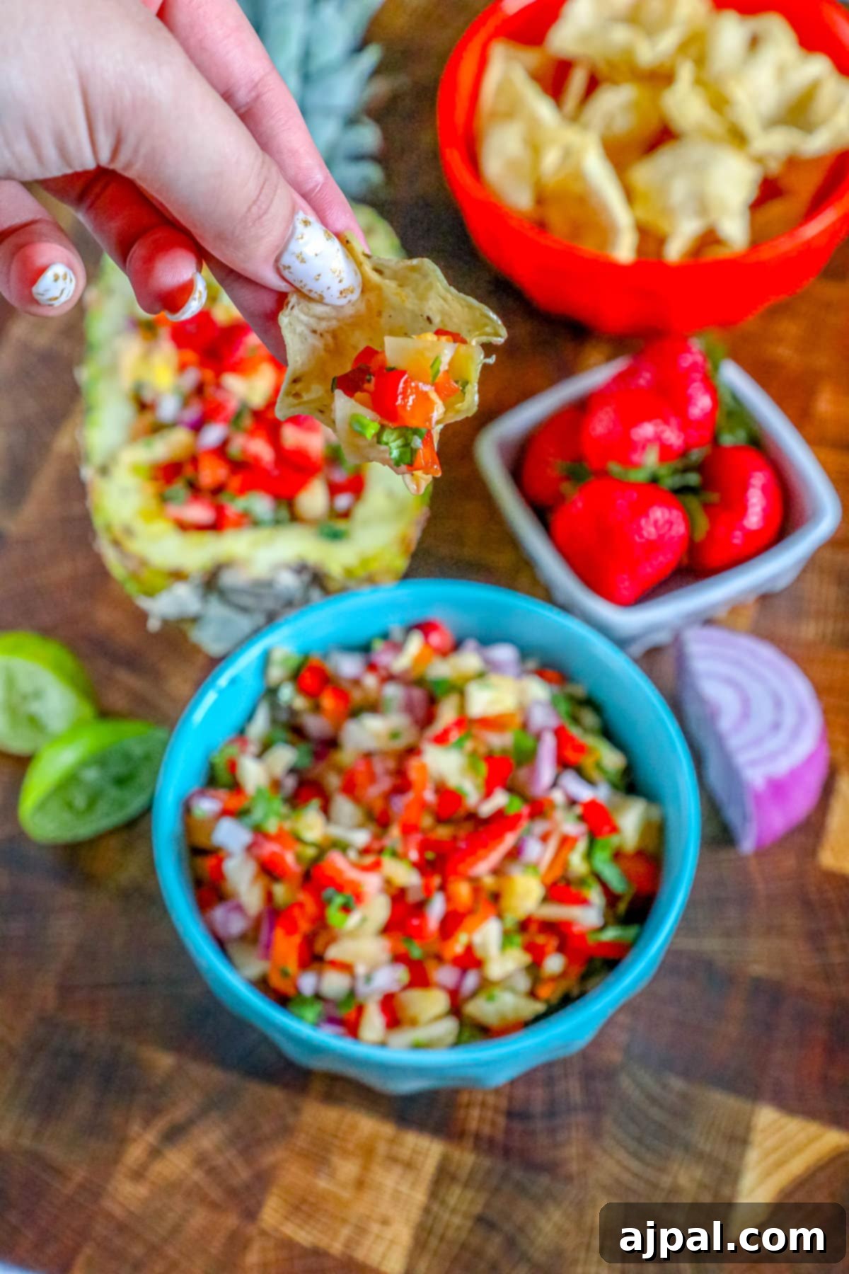 Picture of strawberry pineapple salsa in a hollowed out pineapple, showcasing its full glory.