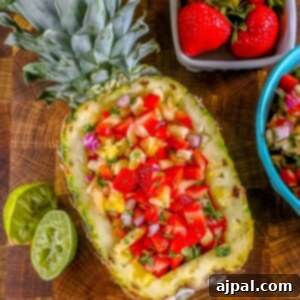 picture of strawberry pineapple salsa in a hollowed out pineapple