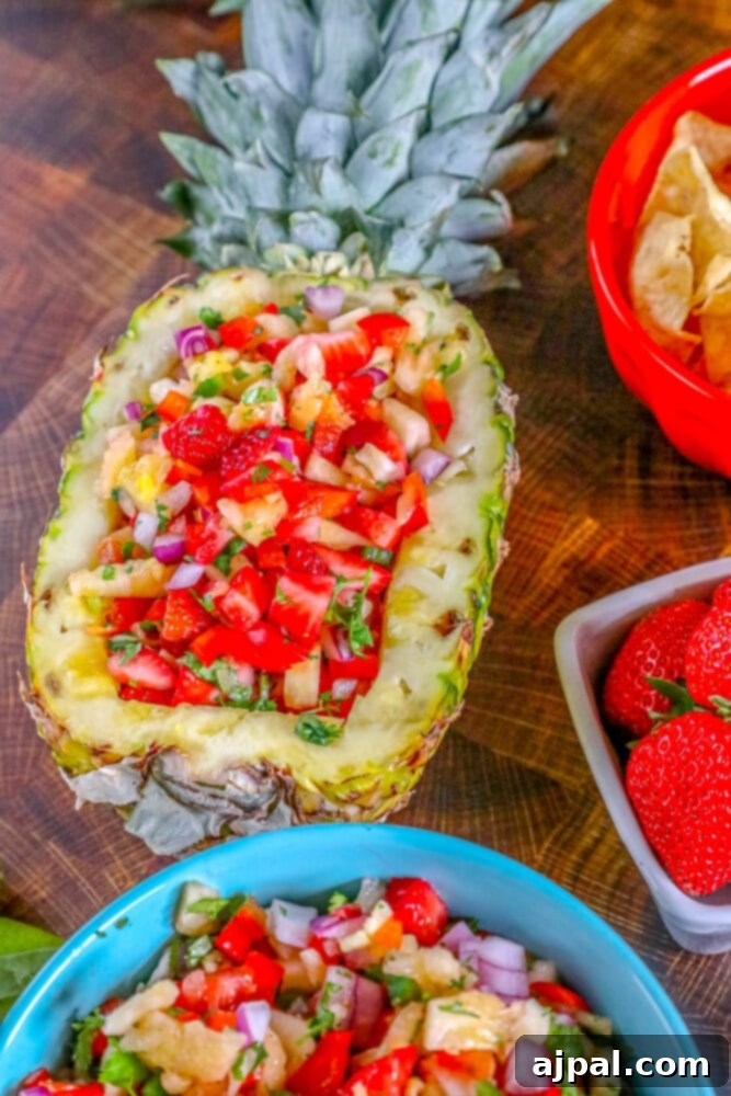 Picture of strawberry pineapple salsa in a hollowed out pineapple, ready to be enjoyed.