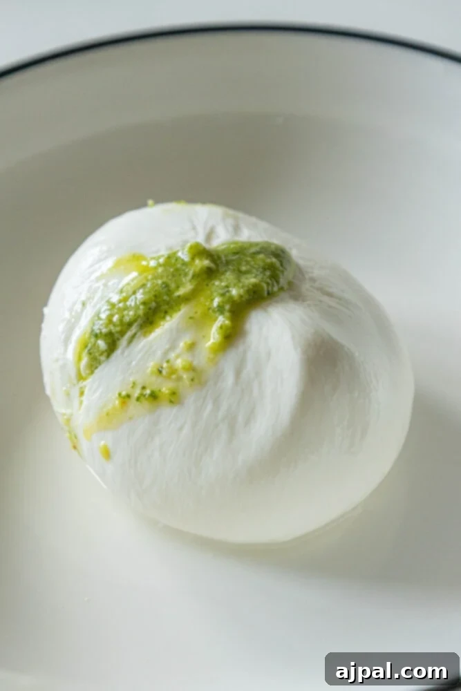 picture of stuffed burrata with pesto spilling out the top