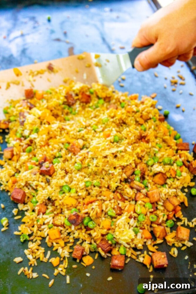 Effortless Spam Fried Rice 11 picture of spatula scooping SPAM fried rice on a griddle