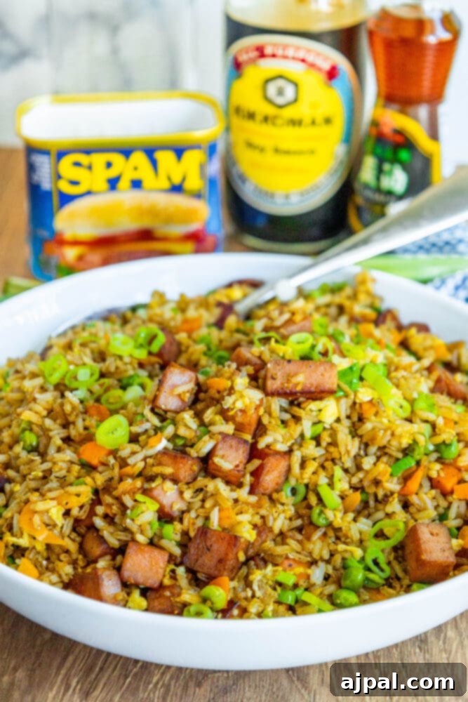 Effortless Spam Fried Rice 3 picture of spam fried rice with peppers, peas, and chopped green onions a bowl