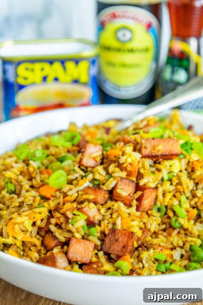 Effortless Spam Fried Rice 15 picture of spam fried rice with peppers, peas, and chopped green onions a bowl