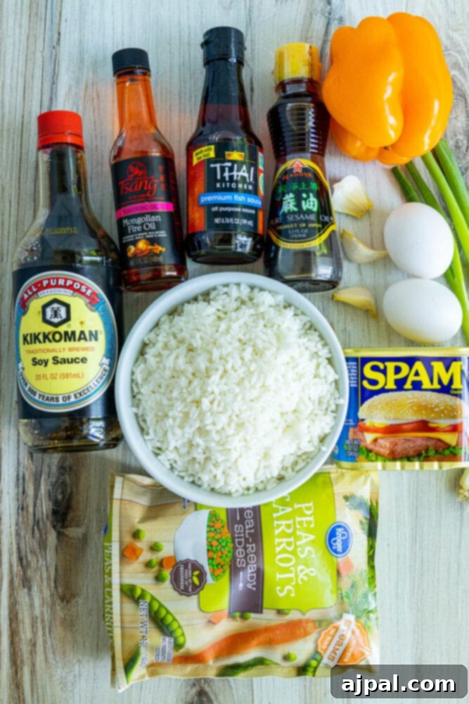 Effortless Spam Fried Rice 4 picture of rice, eggs, soy sauce, fire oil, sesame oil, rice vinegar, spam, frozen peas and carrots, eggs, green onions on a table