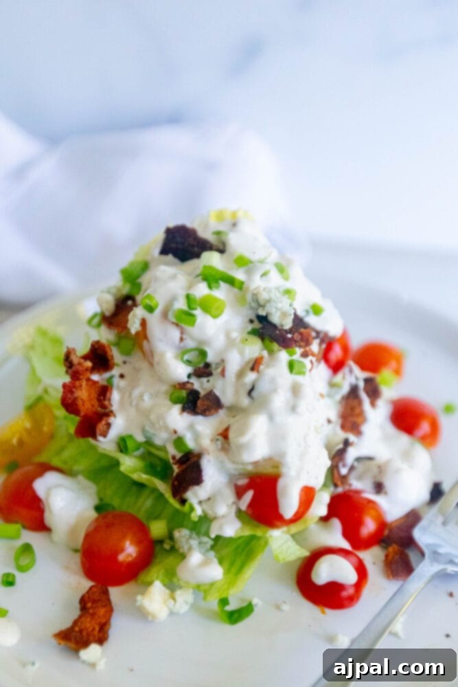 Classic Wedge Salad with Creamy Blue Cheese Dressing 7 Wedge salad with blue cheese dressing, topped with lettuce, tomatoes, and bacon.