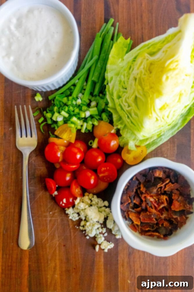 Classic Wedge Salad with Creamy Blue Cheese Dressing 4 Bacon, tomatoes, chives, dressing, and iceberg lettuce set out.