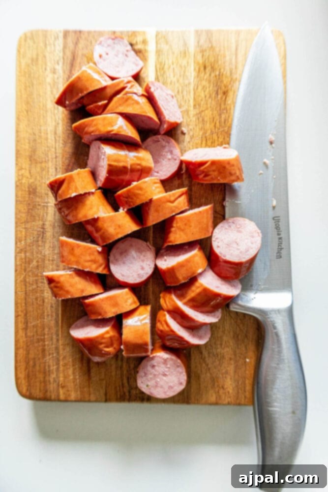 Easy Kielbasa Sheet Pan Dinner 5 picture of sliced turkey kielbasa on a cutting board