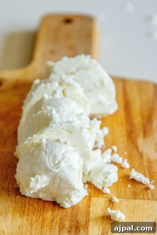 Warm Goat Cheese Bites 6 sliced got cheese on a wooden cutting board