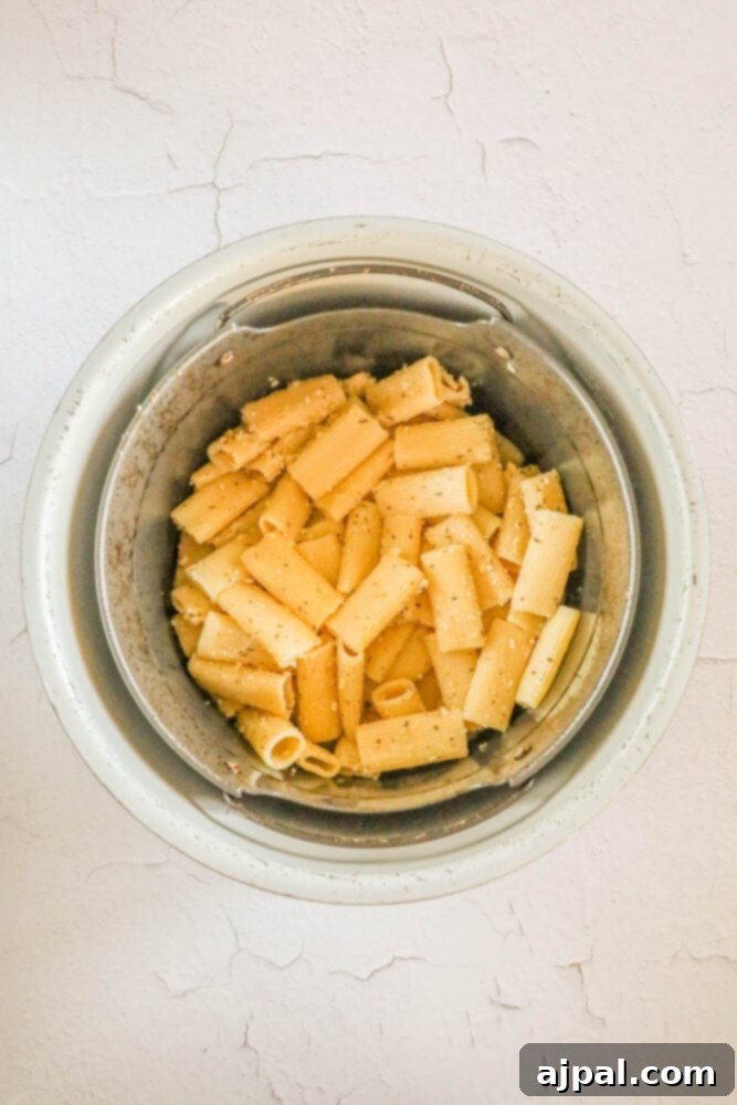 Seasoned pasta chips arranged in an air fryer basket, ready to be cooked to crispy perfection.