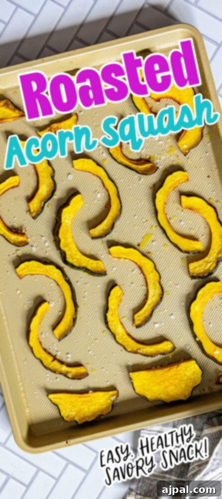 Roasted acorn squash slices on a baking sheet, showcasing their beautiful caramelization and readiness to serve.