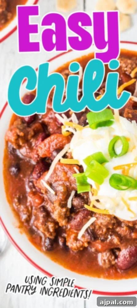 picture of chili in a bowl with sour cream, green onions, and cheese on top