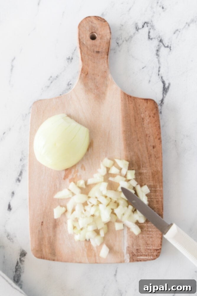 picture of onion being chopped on a cutting board