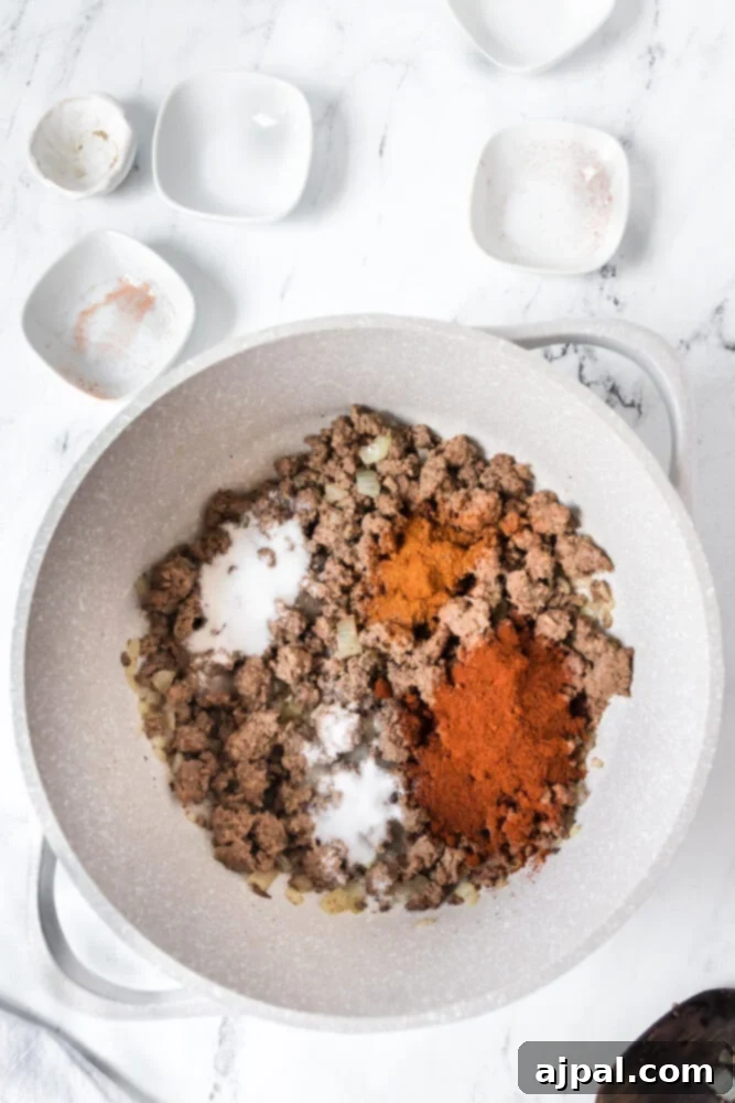 picture of browned ground beef and spices in a pot