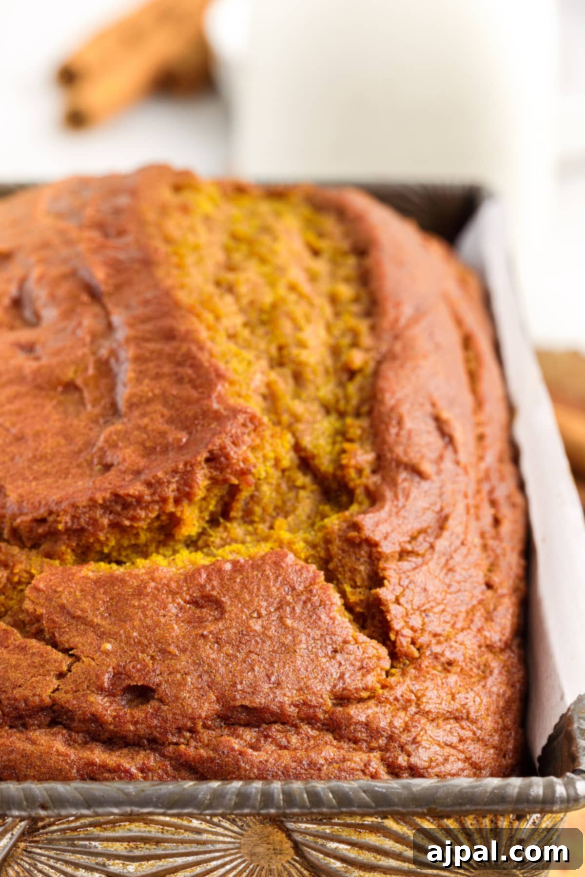 Moist Spiced Pumpkin Loaf 15 Classic Pumpkin Bread with a hint of cinnamon, baked in a metal pan.