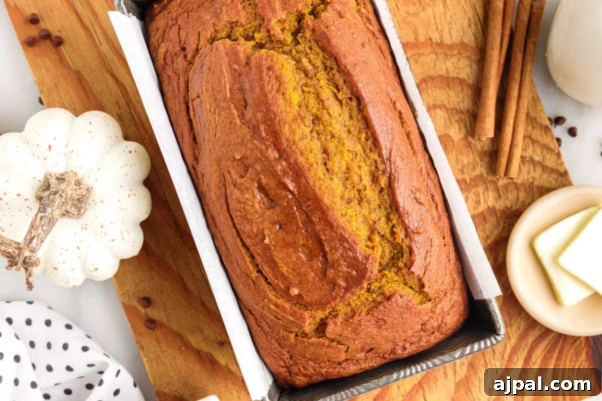 Moist Spiced Pumpkin Loaf 16 A loaf of THE BEST pumpkin bread is sitting on a cutting board.