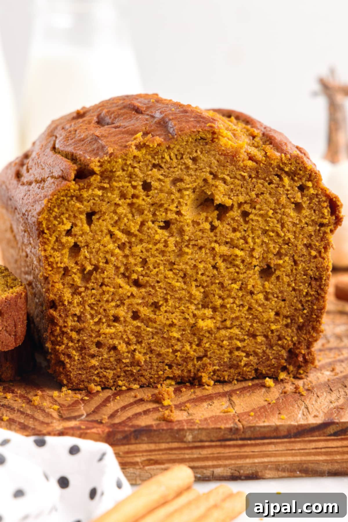Moist Spiced Pumpkin Loaf 4 A slice of the best pumpkin bread on a cutting board.