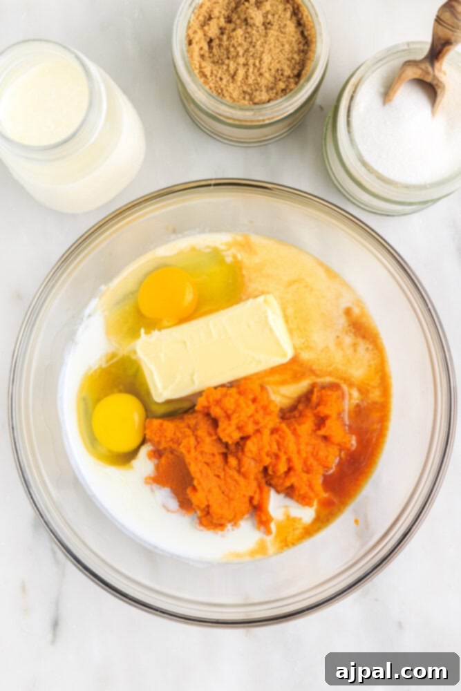 Moist Spiced Pumpkin Loaf 6 picture of eggs, butter, milk, and pumpkin in a bowl