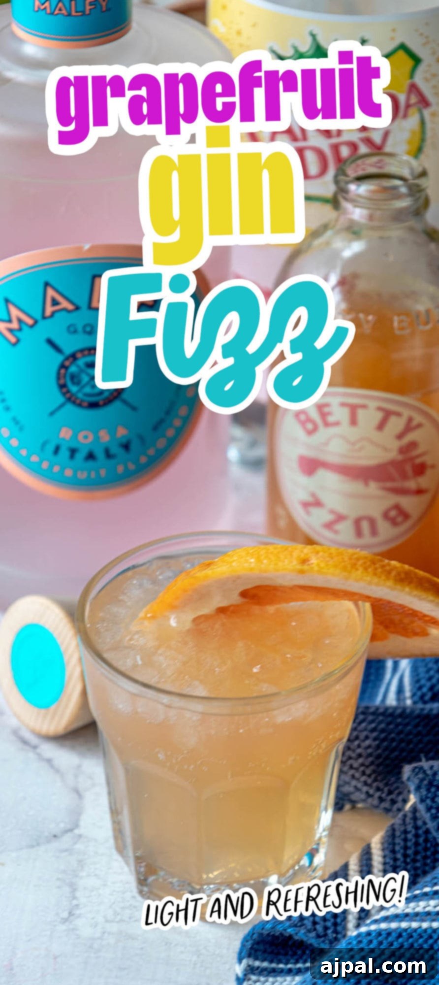 Glass with grapefruit gin fizz, gin, and grapefruit soda in background