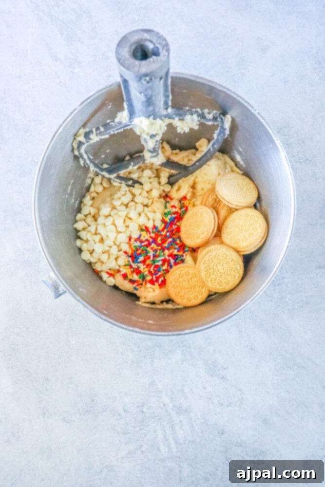 Mega Sprinkle Celebration Cookies 7 A mixer with Jumbo Funfetti Cookies and sprinkles in it.