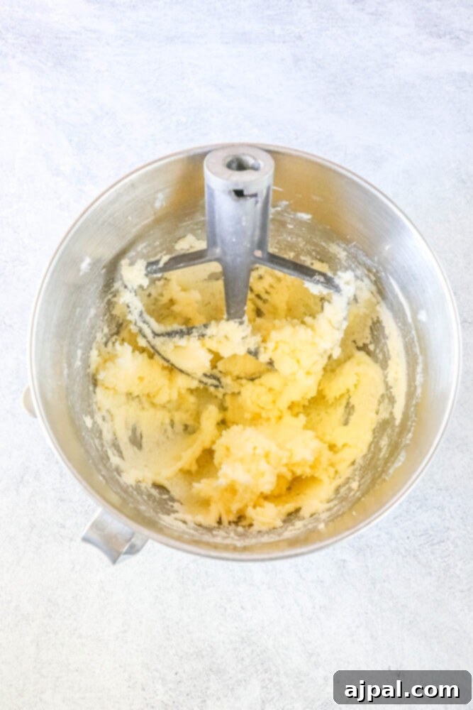Mega Sprinkle Celebration Cookies 9 Large funfetti cookies in a mixing bowl on a white background.
