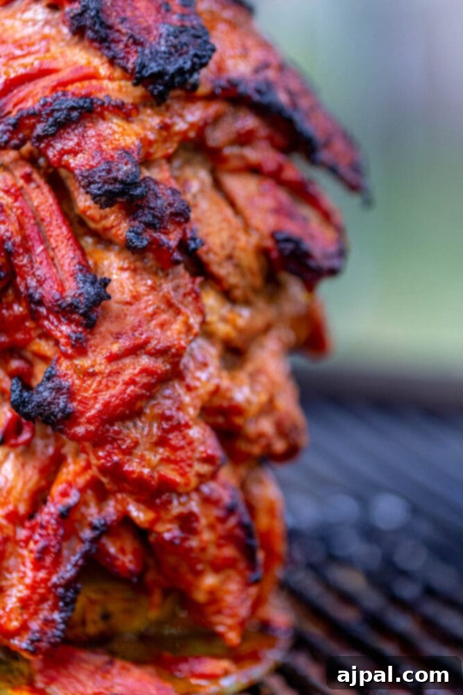 A smoked al pastor recipe is being prepared on a grill.