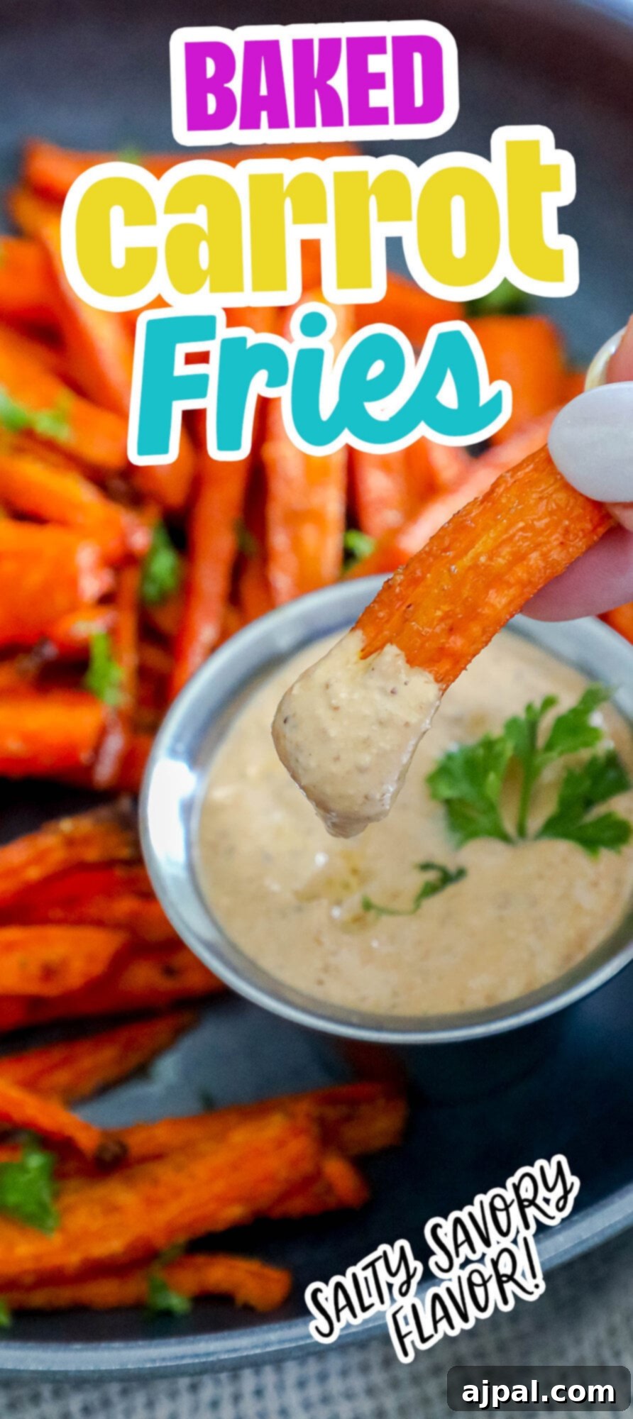 picture of a hand holding a carrot fry dipped in sauce 