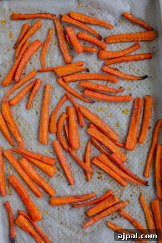 picture of baked carrot fries on a baking sheet lined with parchment paper