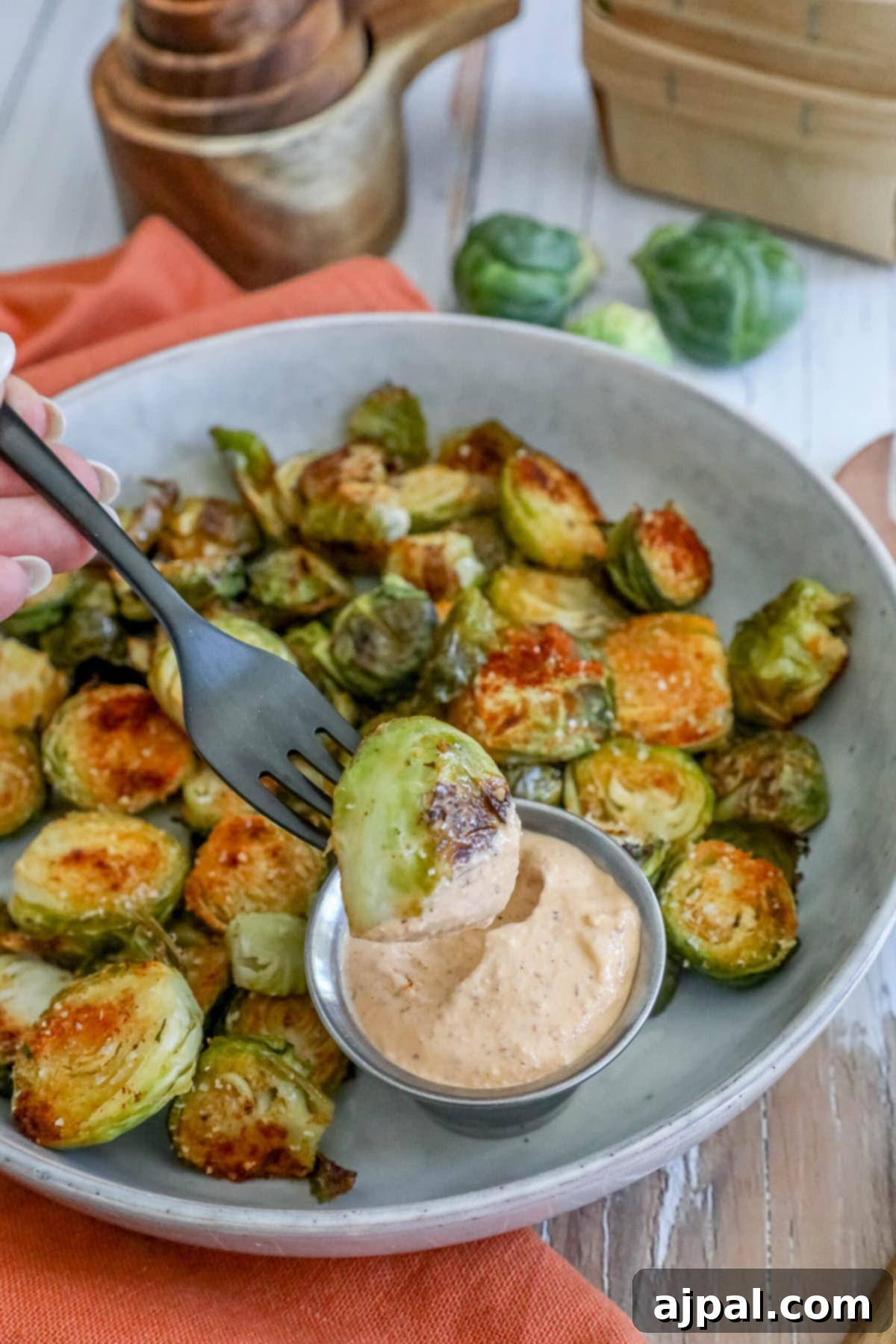 Crispy Garlic Roasted Brussels 10 A white bowl filled with golden-brown garlic roasted Brussels sprouts, perfectly seasoned and ready for serving.