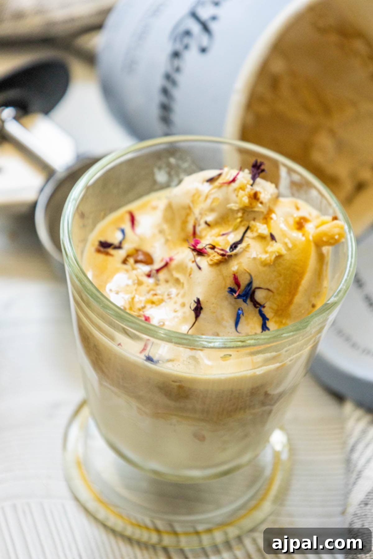 An artistic shot of an Earl Grey Affogato dessert, beautifully garnished with delicate edible flowers.