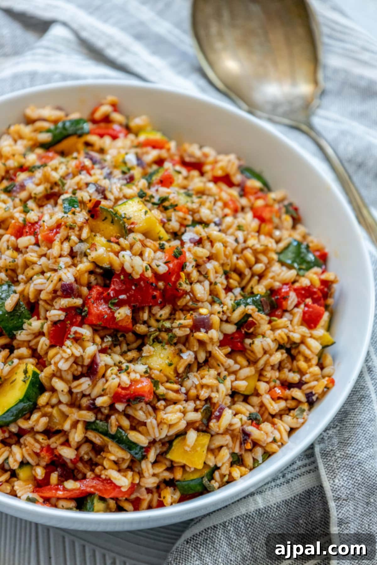 Vibrant Farro Salad with Zucchini and Bell Pepper 7 A bowl of vibrant vegan farro zucchini salad with roasted red pepper, zucchini, and fresh herbs, ready to be enjoyed.