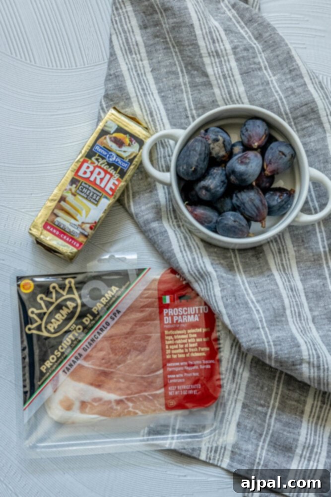 Gourmet Fig, Prosciutto, and Brie Bites 4 Picture of brie, figs, and prosciutto arranged on a table, ready for preparation
