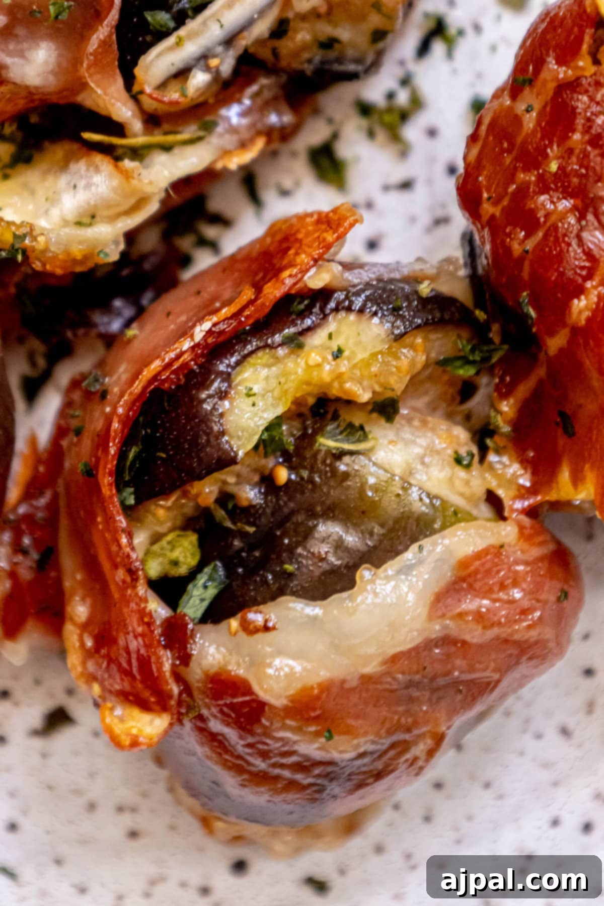 Gourmet Fig, Prosciutto, and Brie Bites 9 Fig stuffed with brie and wrapped in prosciutto on a plate with fresh chives, garnished beautifully