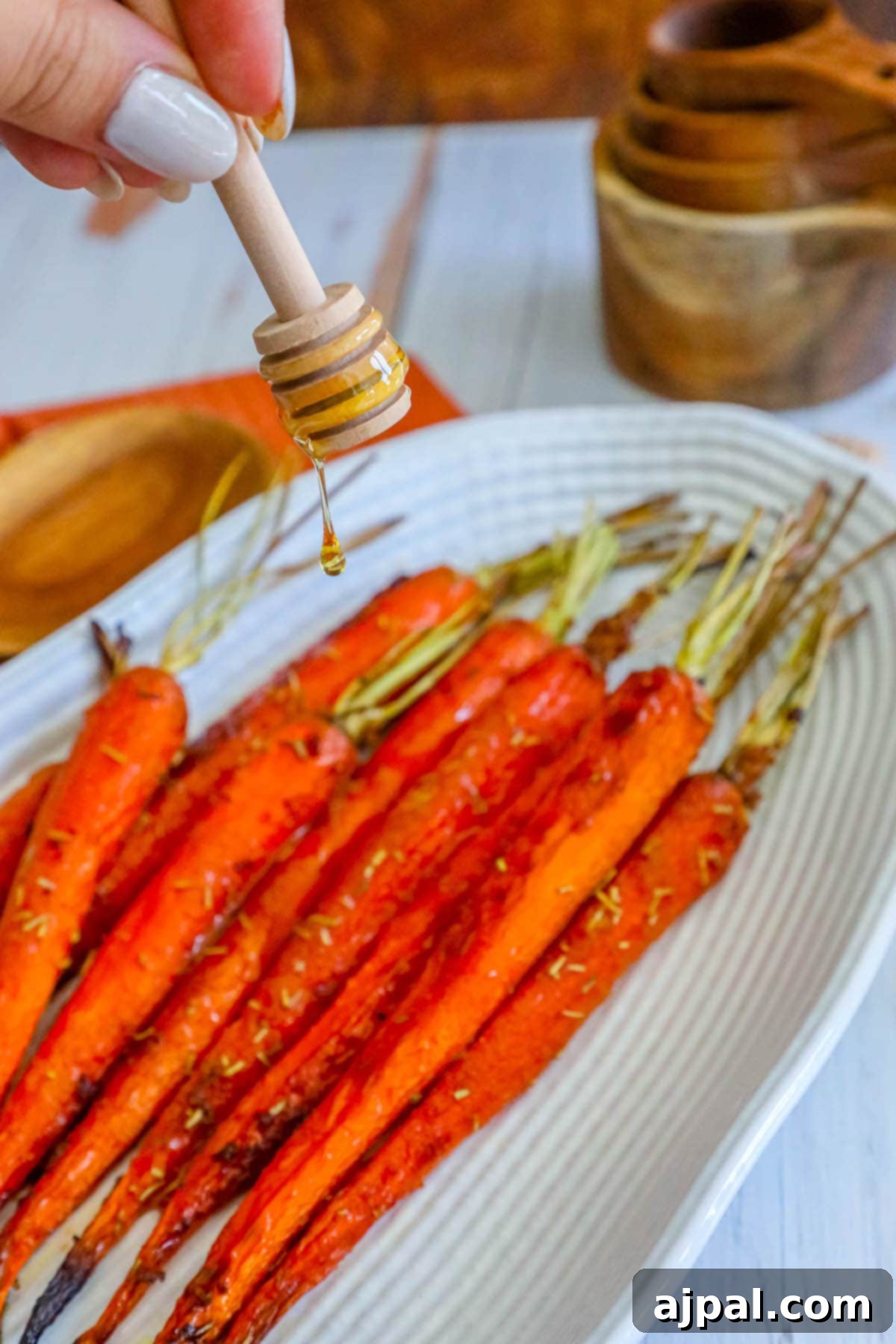 picture of honey garlic carrots on a plate with herbs