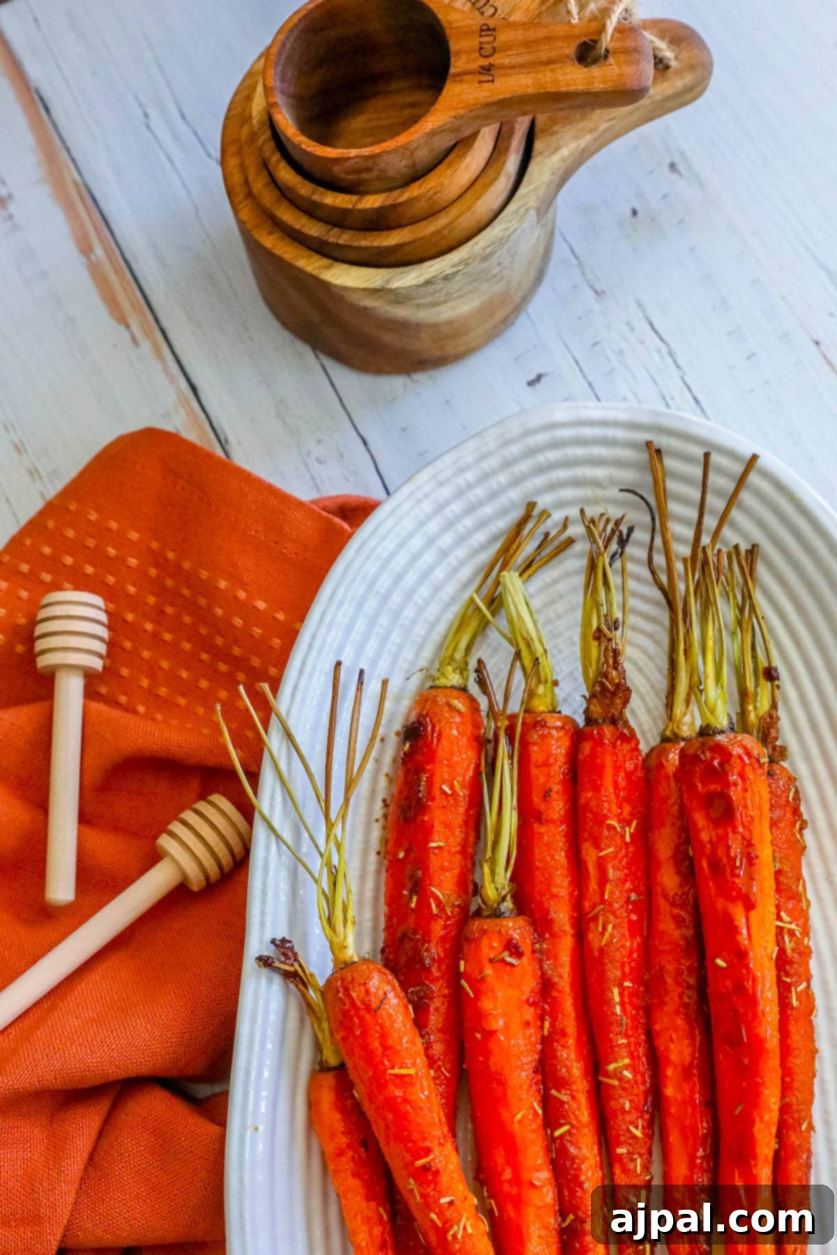 picture of honey garlic carrots on a plate with herbs