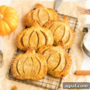 Autumn Pumpkin Pockets 16 picture of pumpkin shaped hand pies on a cooling rack