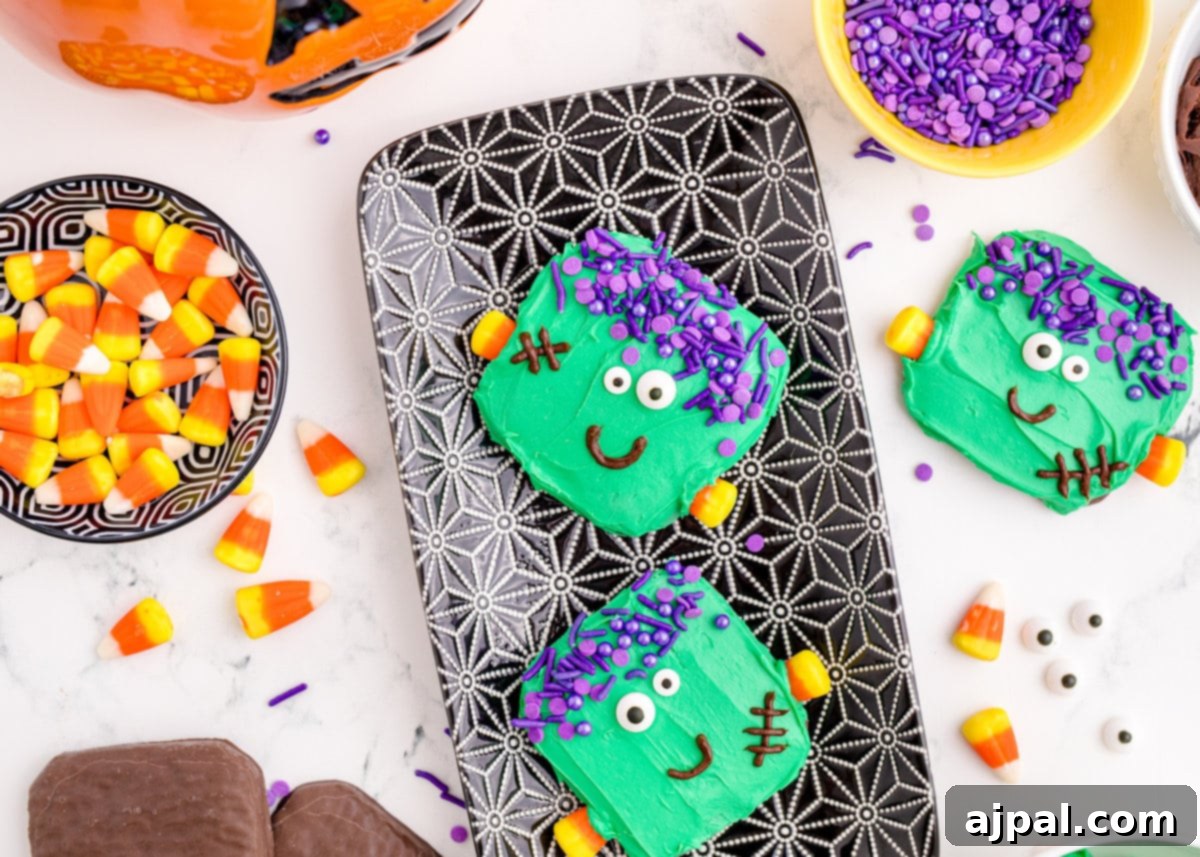 Frankenstein Cookies 6 A charming tray of Halloween cookies and candy, featuring an array of easy Frankenstein cookies with bright green frosting and playful decorations, perfectly arranged for a festive celebration.