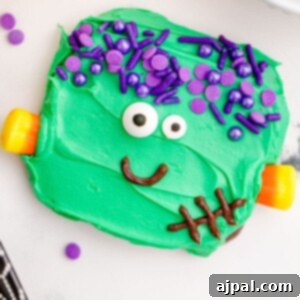 Spooky Frankenstein Cookies 16 Picture of chocolate dipped cookies, covered in green icing with purple sprinkles for hair, candy corn neck bolts, candy eyes, and an icing smile to look like Frankenstein