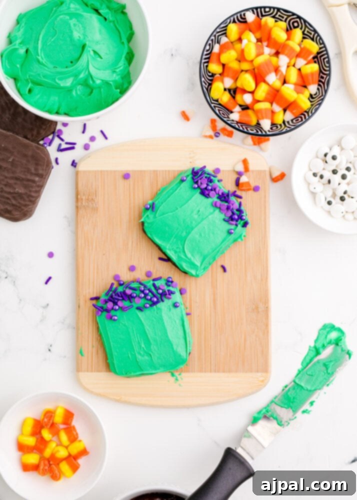Spooky Frankenstein Cookies 8 Green iced cookies with a generous topping of purple sprinkles strategically placed to resemble Frankenstein's hair, awaiting further details.
