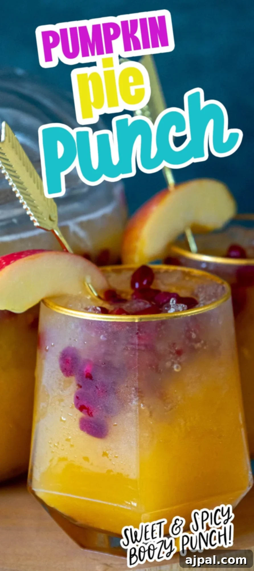 A festive pumpkin cocktail punch with cranberries and apple slices, perfect for autumn gatherings and holiday celebrations.