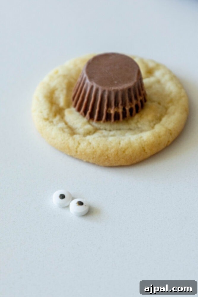 Spooky Spider Cookies 6 A mini Reese's Peanut Butter Cup carefully placed on top of a cookie, forming the spider's body.